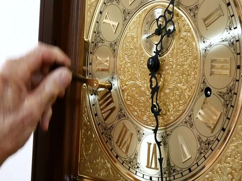 A man winds up a mechanical watch Stock Footage 78028492