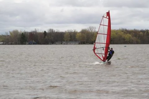 Man windsurfing on a board Stock Photos