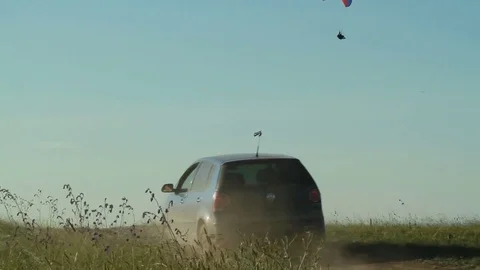A man with a wing flies over the road Stock Footage 79338105