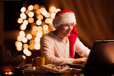 Man winks in cristmas hat Stock Photos