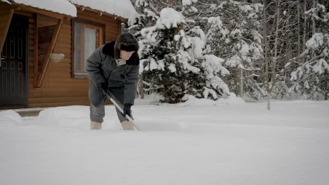 Man In Winter After A Snowfall Cleans Shovel The Walkway To Wooden Home Stock Footage 101641704