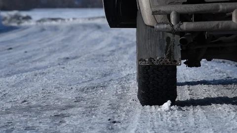 The man in winter in black pants opens the door and gets out of the black car Video stock 100591538