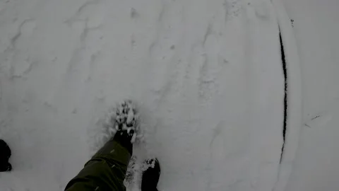 A man in winter boots walking in the snow Stock Footage 167348337