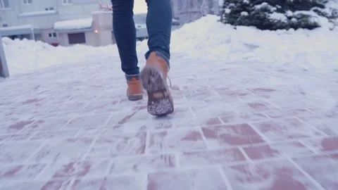 A man in winter boots walks on the sidewalk in winter. Stock Footage 145065232