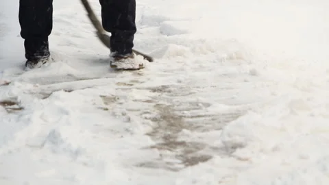 The man in the winter cleans the path from the snow with a shovel Stock Footage 87884298