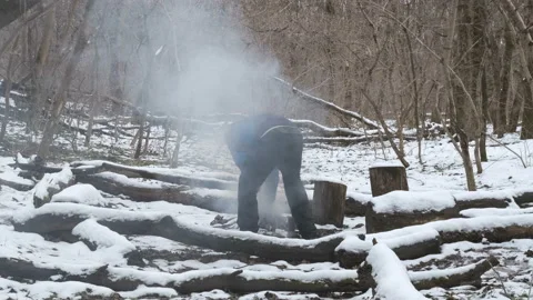 Man in the winter forest kindles a big fire Stock Footage 170445820