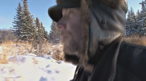 Man in Winter Garb Walking Through Snow Stock Footage 8974866