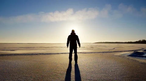 Man on winter ice and sun Stock Footage 48481123