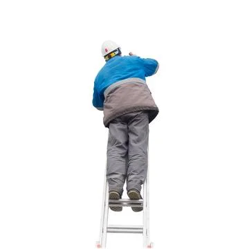 Man in winter work clothes and construction helmet climbs stairs. Male builder Stock Photos