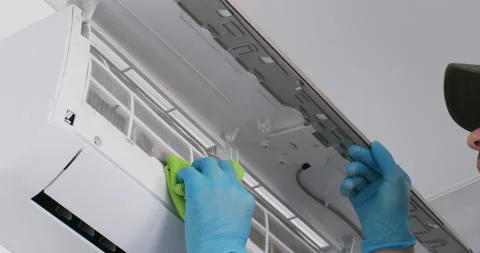 Man wipes conditioner coarse filter from dust with cloth Video stock 205069034