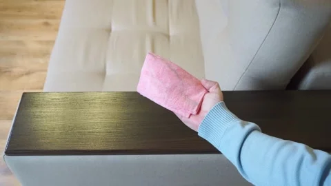 A man wipes a dusty sofa armrest Stock-Footage 321882259