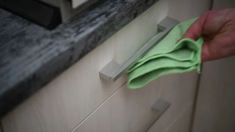 A man wipes the kitchen facade, handles. Cleaning the apartment. Stock Footage 300081807