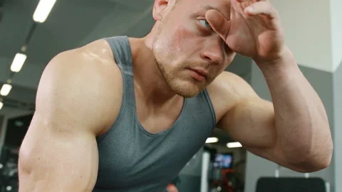 Man wipes sweat from his forehead after workout Stock-Footage 148355355