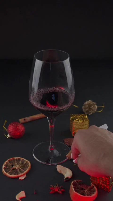 A man wipes a table have glass of red wine with a dark festive background Stock Footage 333718013