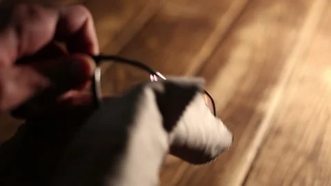 Man wipes vision glasses with a microfiber cloth Stock Footage 148508827