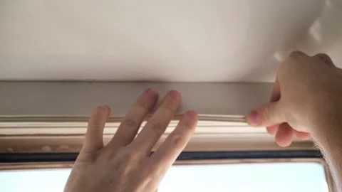 Man wipes window frame with a degreaser and glues a sealing rubber tape on it Stock Footage 235676376