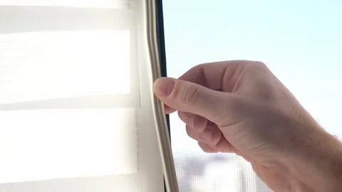 Man wipes window frame with a degreaser and glues a sealing rubber tape on it Stock Footage 236423762