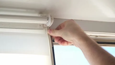 Man wipes window frame with a degreaser and glues a sealing rubber tape on it Stock Footage 236921872
