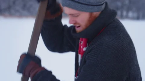 Man Wiping Sweat From Forehead While Working on Frozen Lake Stock Footage 328499951