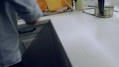 Man wiping white table surface with yellow cloth in kitchen cleaning routine Vidéo 324816919
