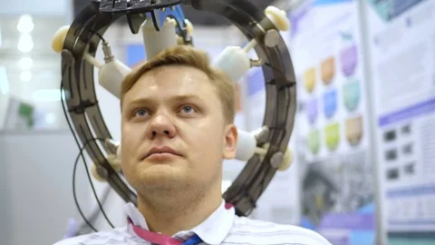 Man wired to an EEG machine or electroencephalograph which produces a graphical Stock Footage 81519075