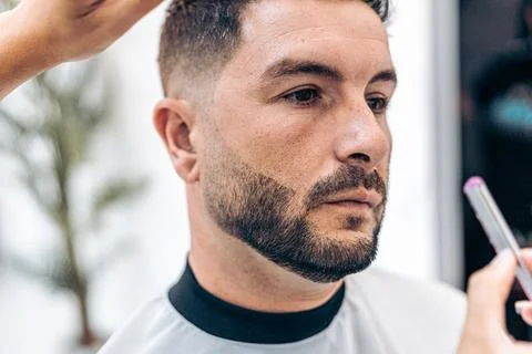 Man wit relaxed expression while being shaved with a manual razor Stock Photos