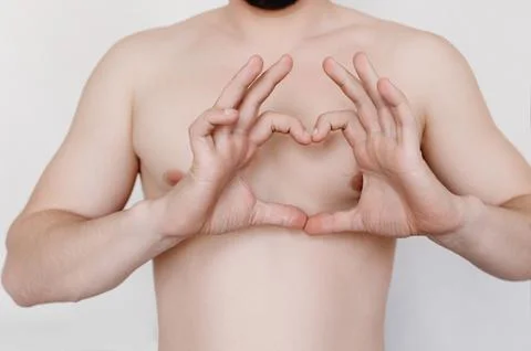 A man without clothes folded his heart out of his hands Stock Photos