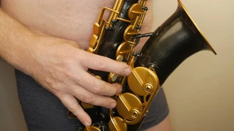 A Man Without Clothes Playing An Old Saxophone Vídeo Stock 153370046