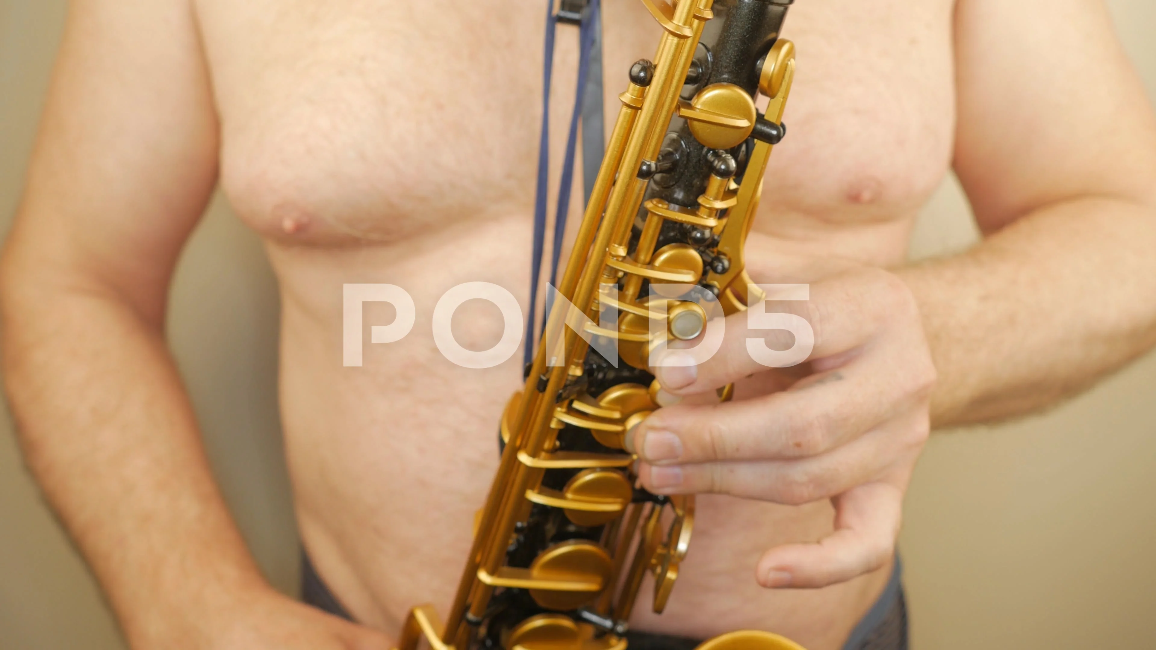 A Man Without Clothes Playing An Old Saxophone