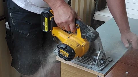Man without face,hands in frame,saws old chipboard furniture for recycling Stock Footage 156573448