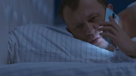 A man woke up at night with a wake-up call, he quickly got out of bed Stock Footage 130199795