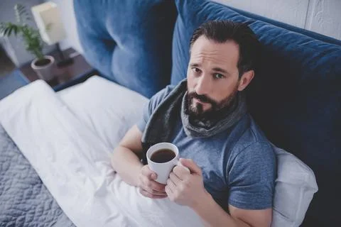 Man woolen scarf in the bed Stock Photos