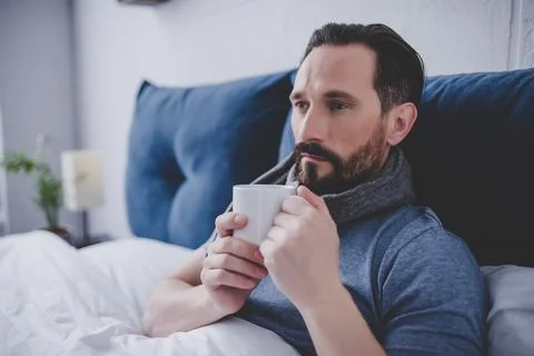 Man woolen scarf in the bed Stock Photos