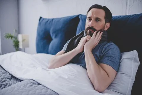 Man woolen scarf in the bed Stock Photos