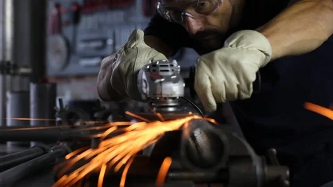Man work with angle grinder, goggles and construction gloves, grinder metal i Stock Footage 118609747