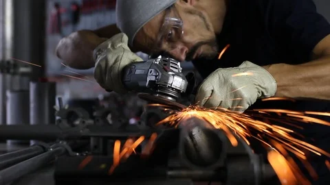 Man work with angle grinder, goggles and construction gloves, grinder metal i Stock Footage 118610520