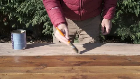 Man at work with brush. Impregnating agent for wood 動画素材 146759162