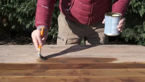 Man at work with brush. Impregnating agent for wood 動画素材 146760356