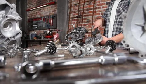 Man work brush part of the engine with wire brush,  repair and cleaning motor Stock Photos