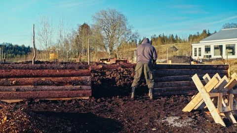Man In Work Clothes And Boots At Timber Construction Site Stock Footage 346793097