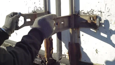 A man in work clothes closes the white doors of the truck body and snaps locks Stockbeeldmateriaal 232802405