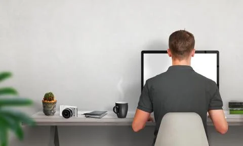     Man work on computer. Coffee, cactus, camera, books on table. Free space on  Stock Photos