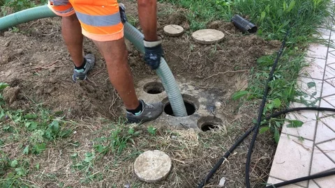 Man at work during a septic tank cleaning of a kitchen Stock Footage
