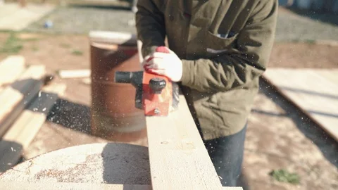 A man work with electric cutting machines. A man planed wood, building house Stock Footage 130047506