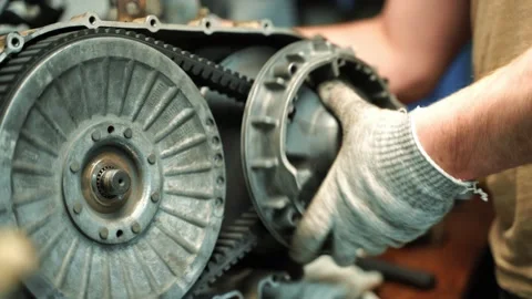 A man in work gloves assembles a CVT box for an ATV, repair work Vidéo 156034879