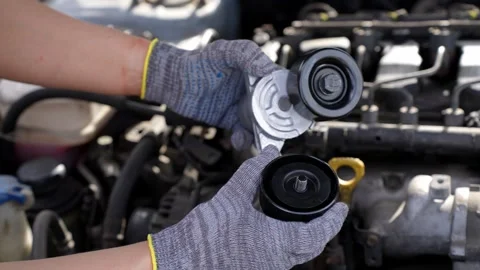 Man in work gloves holds against background of engine compartment of car Stock Footage 323054896