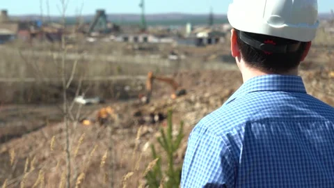 A Man in a Work Helmet Inspects a Construction Site Stock Footage 152468737