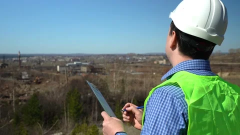 A Man in a Work Helmet Inspects a Construction Site Stock Footage 152468781