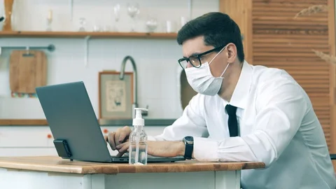 Man work at home in quarantine during covid-19 outbreak. A man on quarantine is Stock Footage 128402544