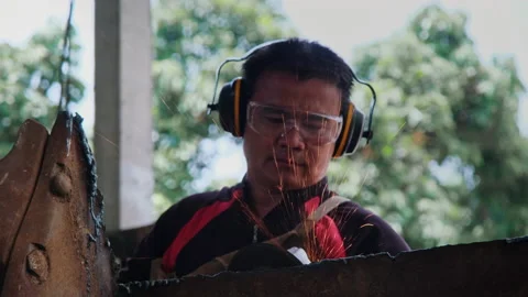 Man work in home workshop with angle grinder, goggles and construction gloves. Video stock 185363938